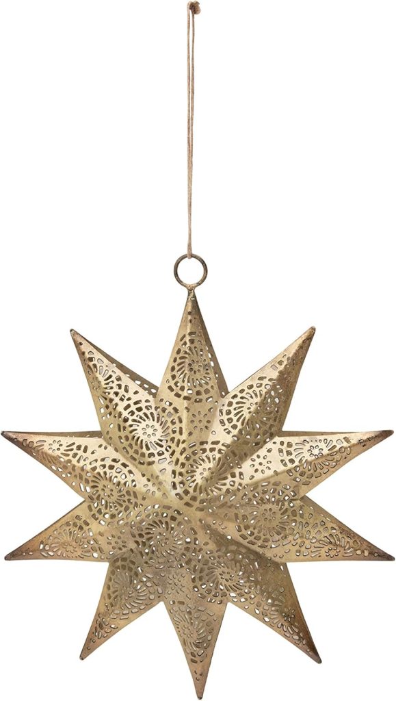 A gold, intricately patterned metal star ornament with a string loop for hanging.