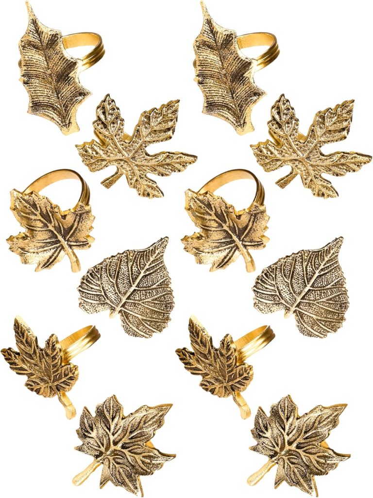 A set of twelve gold-colored metal napkin rings and decorative leaf ornaments, each shaped like a different type of leaf.