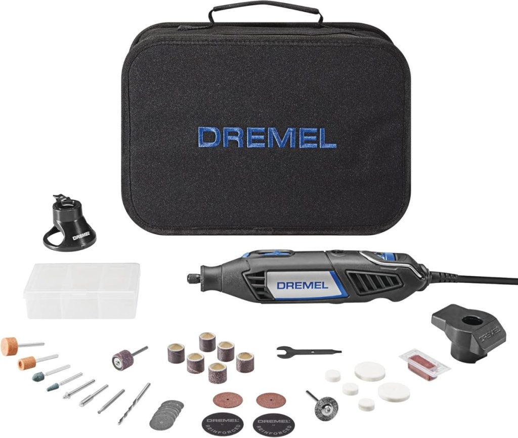 A Dremel rotary tool kit is displayed with its black carrying case, multiple attachments, accessories, and small parts organized below the tool.
