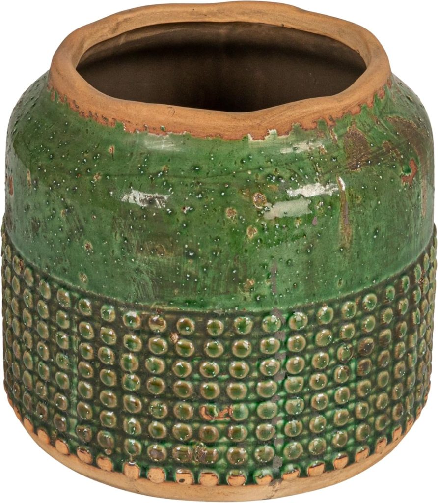 A round ceramic pot with a green glazed finish, textured dot pattern around the bottom half, and unfinished edges at the top and base.