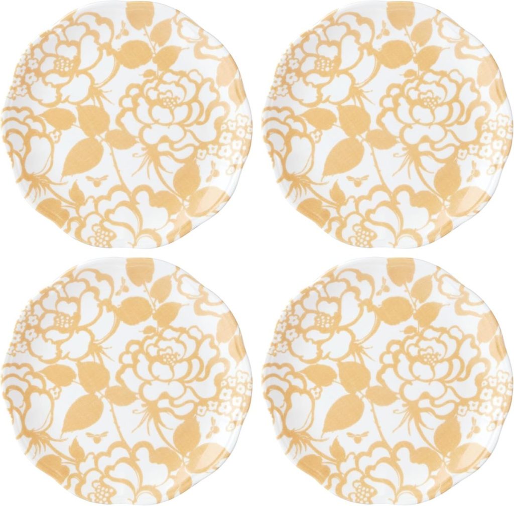 Four round plates with a yellow floral pattern are arranged in a two-by-two grid on a white background.