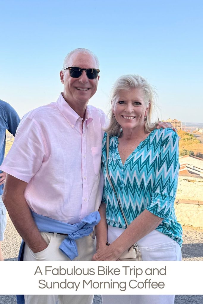A man and woman standing close together outdoors, smiling at the camera on a sunny day. The text below reads, "A Fabulous Bike Trip and Sunday Morning Coffee.