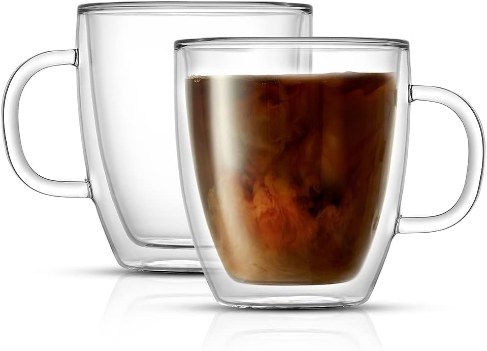 Two transparent double-walled glass mugs, one empty and one filled with coffee swirling with milk, sit side by side on a white background—a perfect pair to discover during Amazon Prime Big Deal Days.