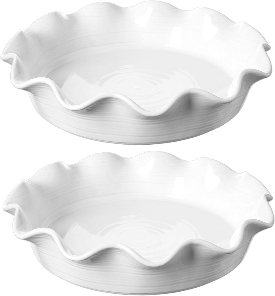 Two white ceramic pie dishes with fluted edges, stacked one above the other on a plain background—perfect for baking your favorite pumpkin pie.