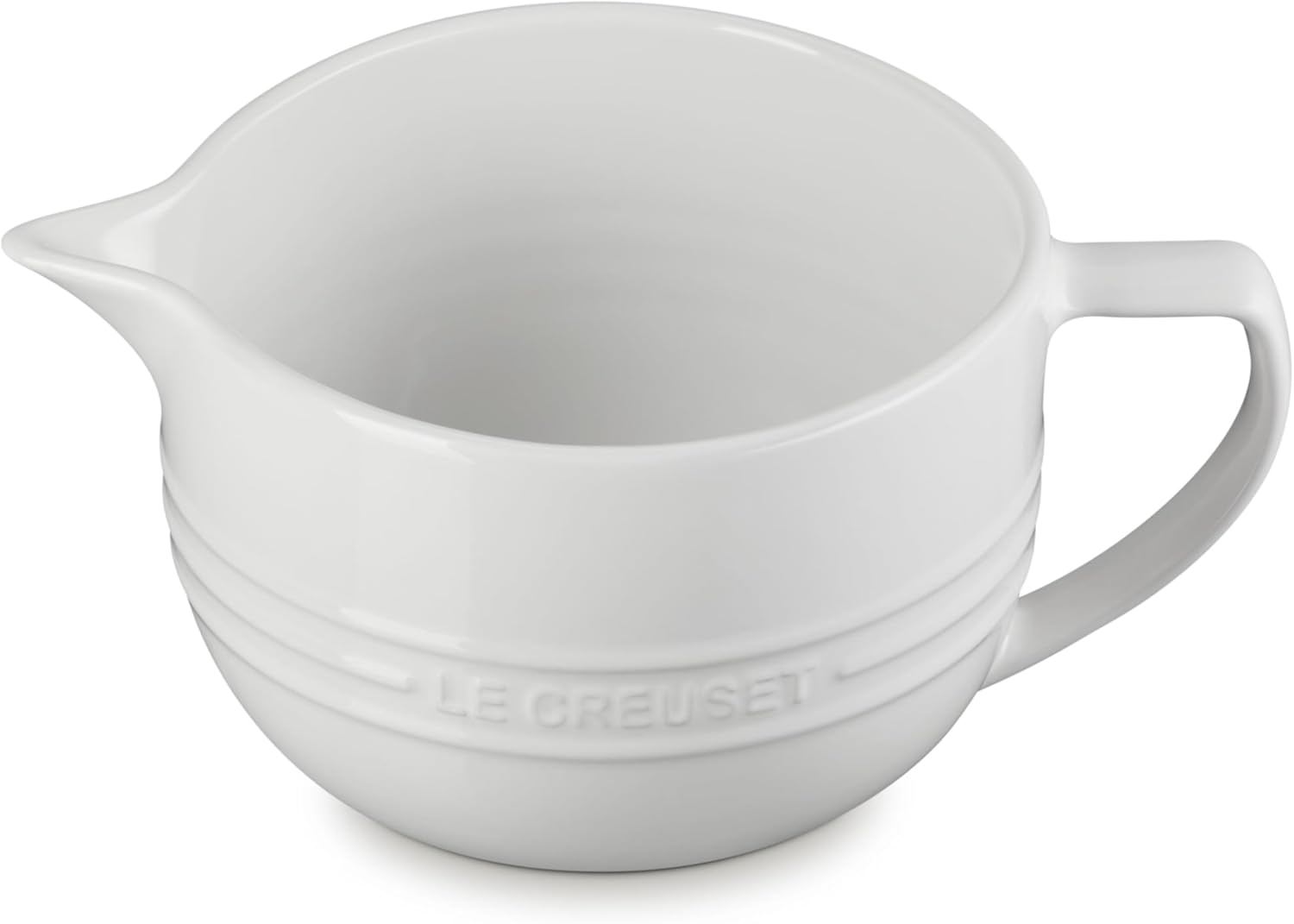 A white ceramic Le Creuset batter bowl with a handle and pouring spout, featuring embossed brand lettering on the side—perfect for your kitchen and available during Amazon Prime Big Deal Days.