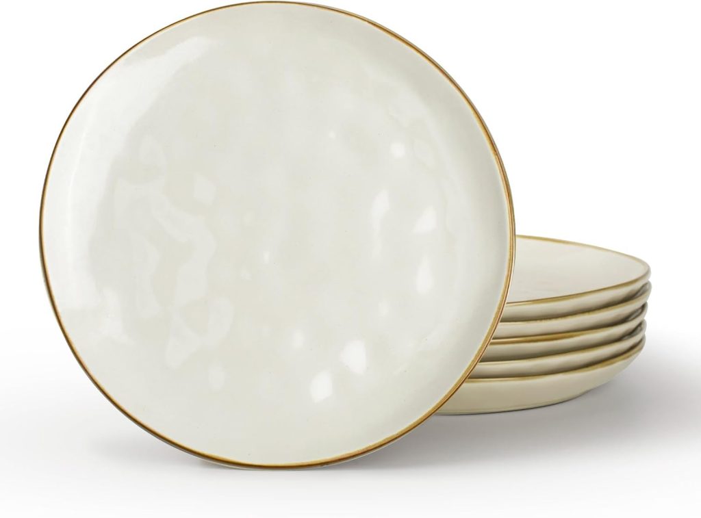 A stack of six round, off-white ceramic dinner plates with a thin gold rim, perfect for serving dishes like Marry Me Chicken, shown on a white background.
