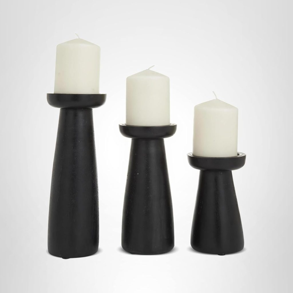 Three white pillar candles sit atop black, modern, cone-shaped candle holders of varying heights against a plain white background—an elegant decor upgrade perfect for Amazon Prime Big Deal Days.