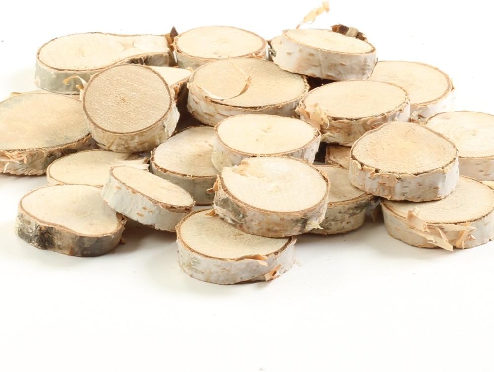 A pile of round, thin slices of tree branch with light-colored wood and rough bark edges, perfect for crafting Glitter Christmas Trees, arranged on a white surface.