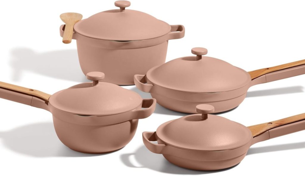A set of four pink pots and pans with matching lids and wooden handles, arranged on a white background—perfect for upgrading your kitchen during Amazon Prime Big Deal Days.