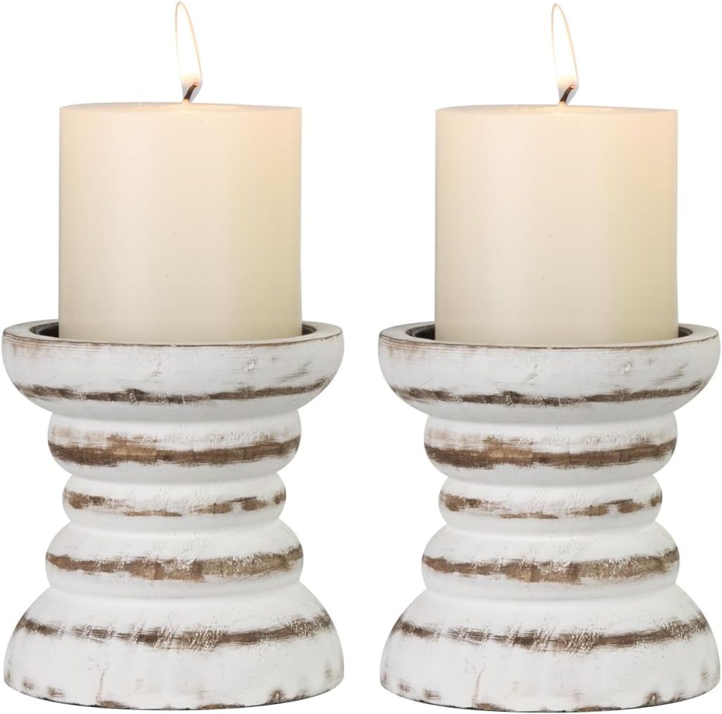 Two lit pillar candles placed on matching distressed white wooden candle holders, perfectly complementing rustic Burlap Christmas Trees for a cozy holiday look.