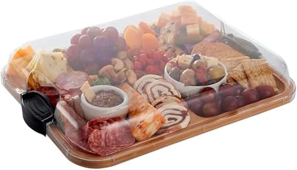 A wooden serving tray with assorted cheeses, meats, crackers, fruits, and dips, covered by a transparent plastic lid—perfect for gatherings and featured in Amazon Prime Big Deal Days.