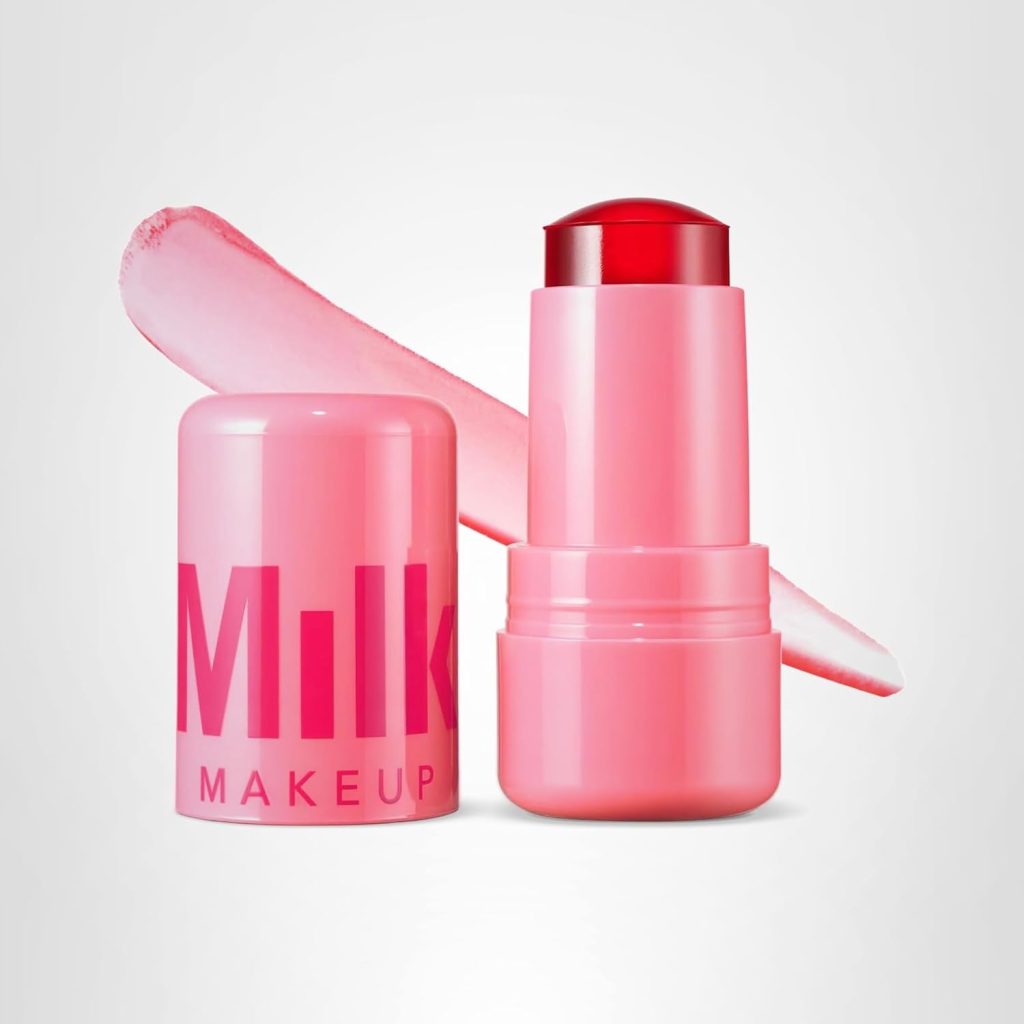A pink tube of Milk Makeup cream blush with the lid off, showing the product and a swatch behind it on a white background, perfect for trying new beauty trends during Amazon Prime Big Deal Days.