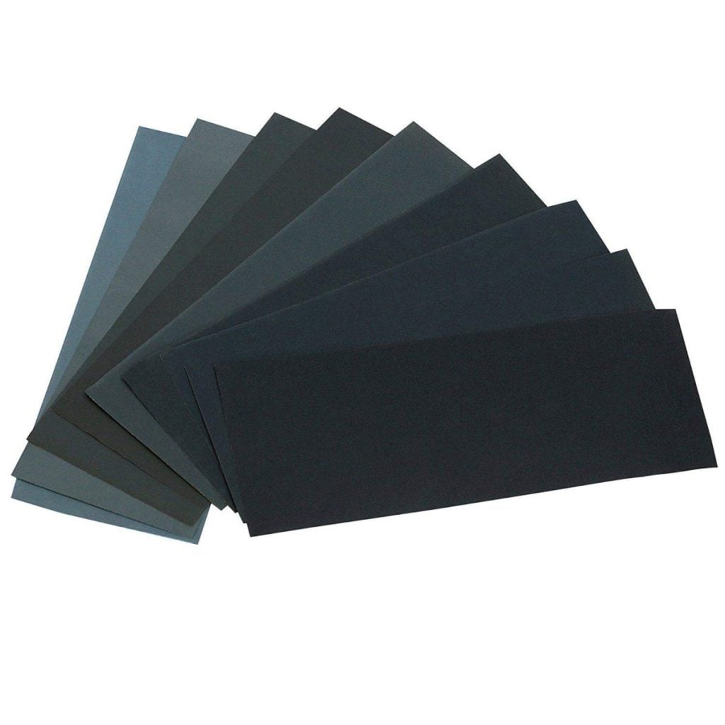 A fan arrangement of black and gray rectangular sandpaper sheets displayed on a white background.