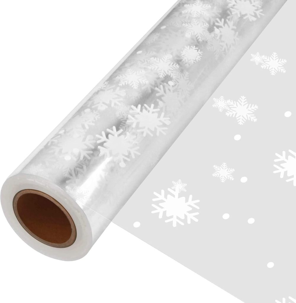 A roll of clear plastic wrapping film with white snowflake and dot patterns printed on it.