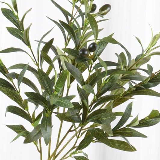 A hand holding several stems of artificial olive branches with green leaves and dark olives, against a white background—perfect décor for those who love pie for breakfast and Mediterranean charm.