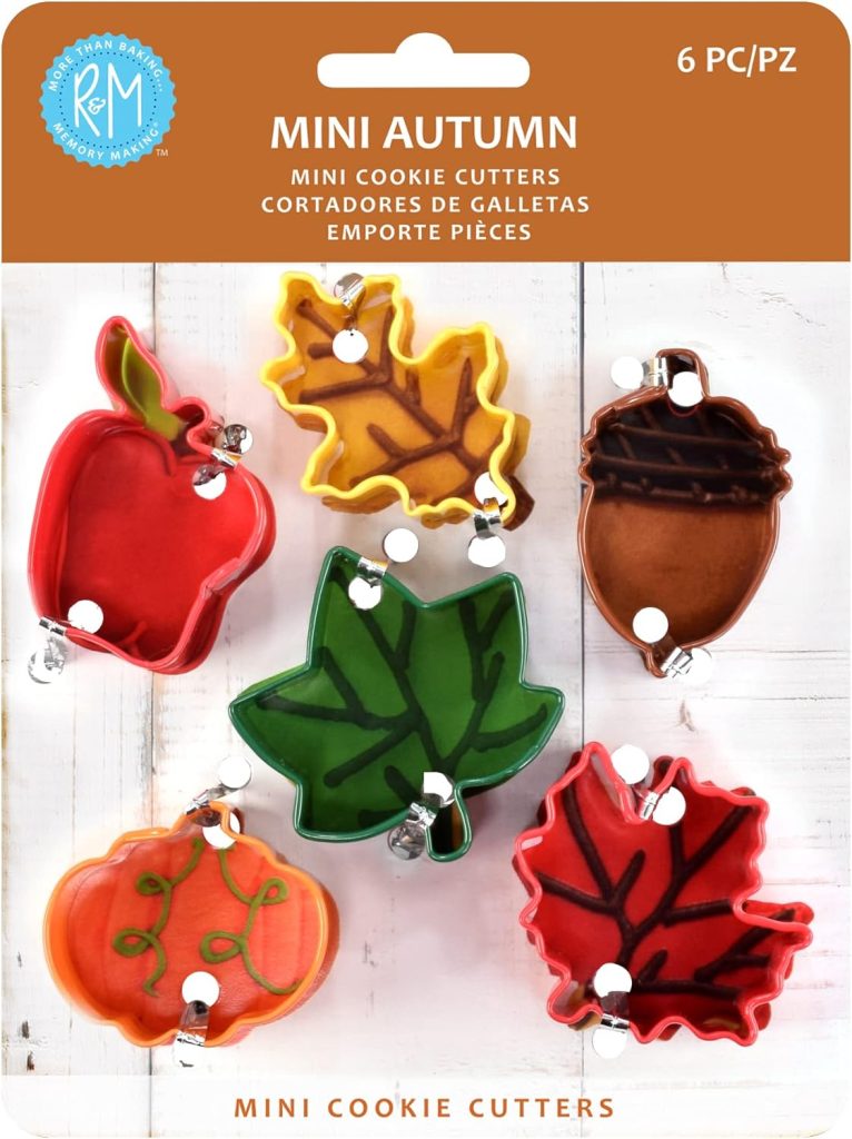 Six mini autumn-themed cookie cutters in shapes of an apple, leaf, acorn, pumpkin, and two other leaves, perfect for making pumpkin pie treats, displayed on a card labeled "Mini Autumn" with a white background.
