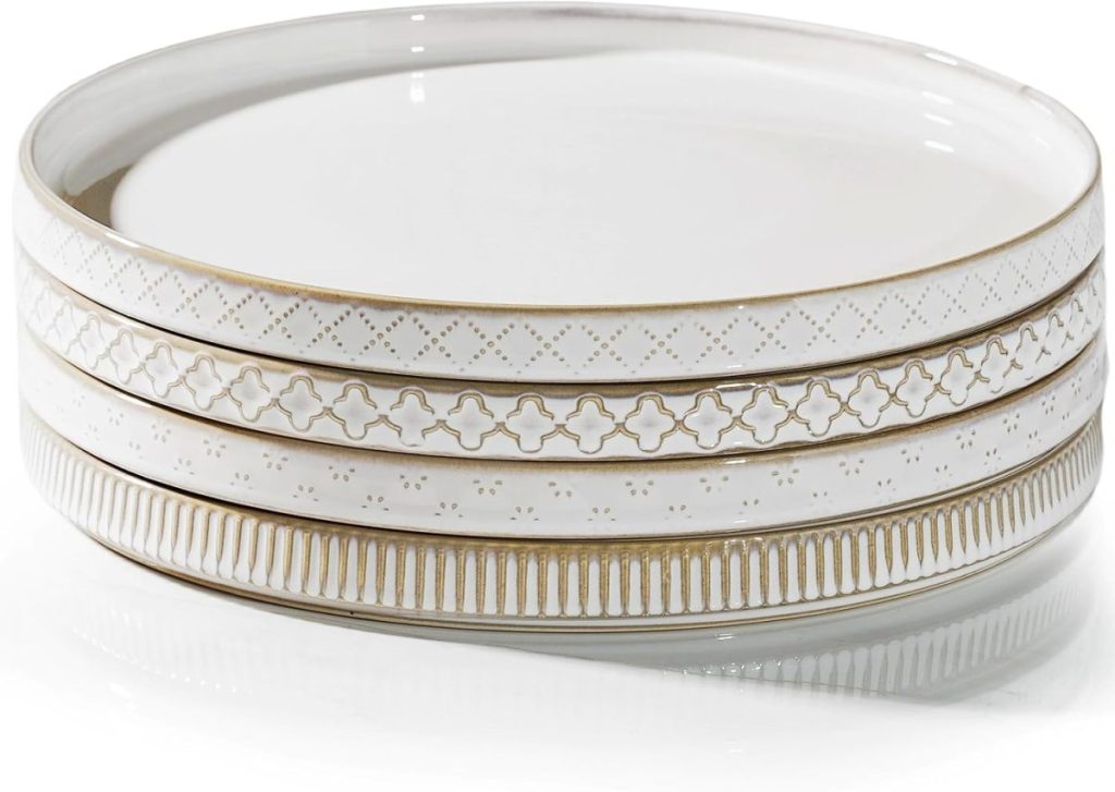 Three white ceramic plates with gold accents and different geometric patterns are stacked on top of each other—perfect for serving a delicious Marry Me Chicken dinner in style.