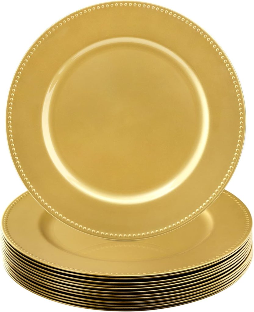 A stack of shiny gold plates with a beaded rim design, with one plate standing upright at the front.