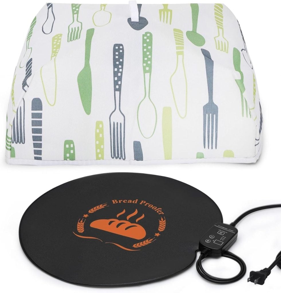 A bread proofing mat with a control switch, featuring a bread illustration, sits in front of a cloth cover with green and gray kitchen utensils—perfect for mastering how to make a sourdough starter at home.
