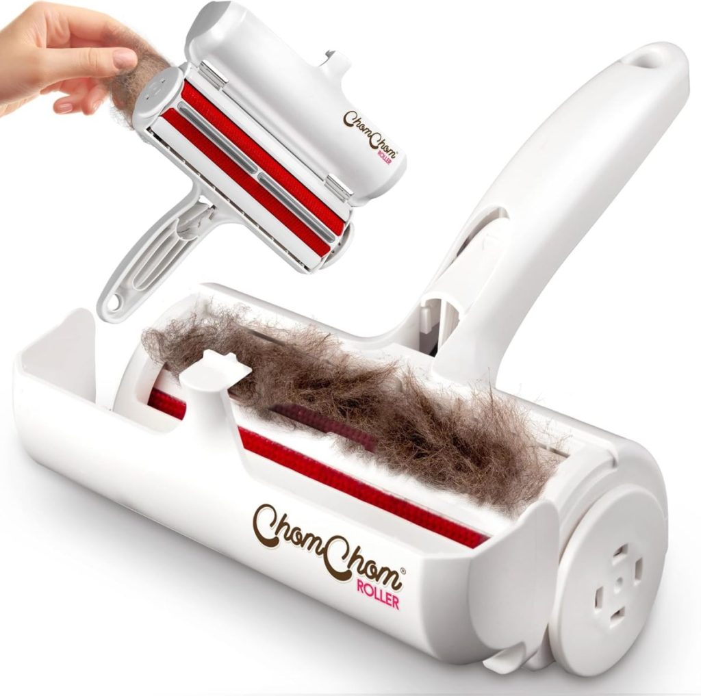 A hand uses a ChomChom Roller pet hair remover, showing collected hair inside the device and the roller’s open compartment—perfect for tackling fur during Amazon Prime Big Deal Days.