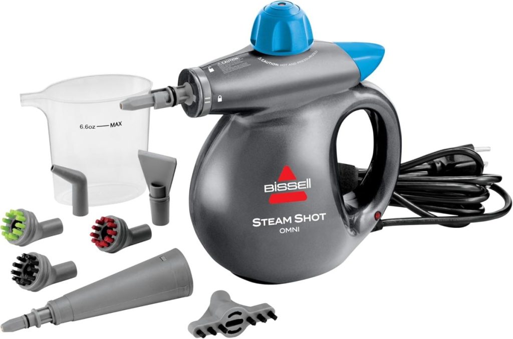A Bissell Steam Shot handheld steam cleaner is shown with multiple nozzle attachments, a measuring cup, and a power cord, all displayed on a white background—perfect for Amazon Prime Big Deal Days savings.