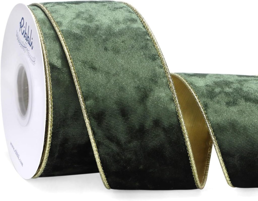 A spool of dark green velvet ribbon with gold edging, partially unrolled, shown against a white background.