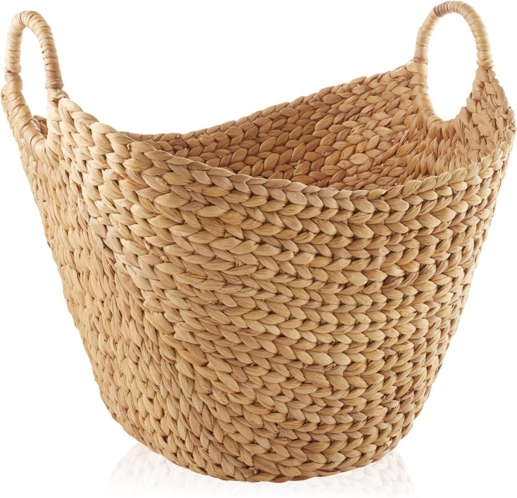 A woven, light brown basket with two handles, made from thick, braided natural fibers, sits empty on a white background&mdash;perfect for styling your Airbnb in Waco.