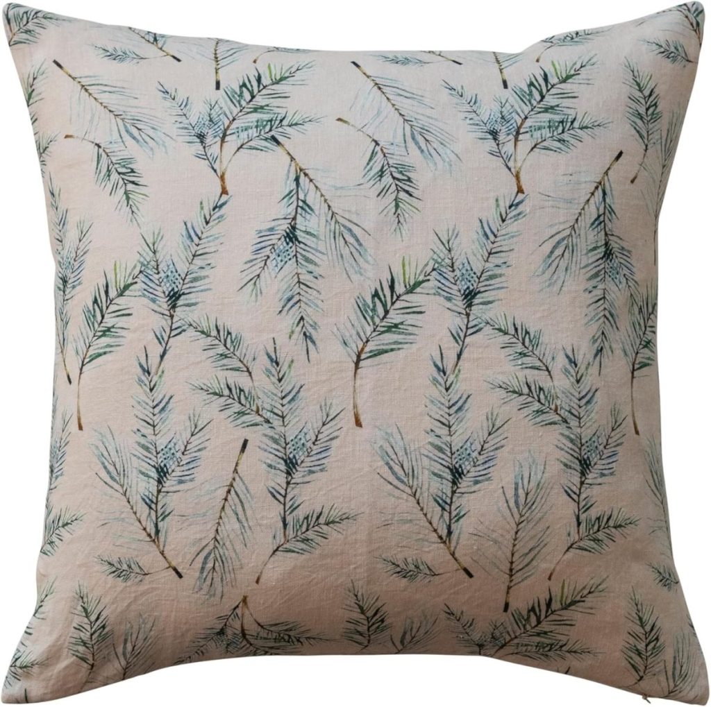 Square throw pillow featuring a pattern of green pine needles on a light beige background.
