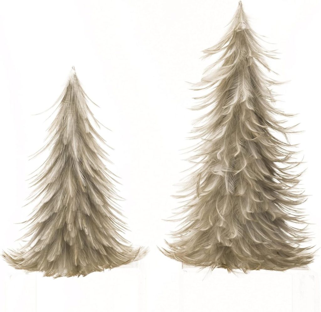 Two artificial trees made of layered, light brown feathers, standing side by side on a white background.