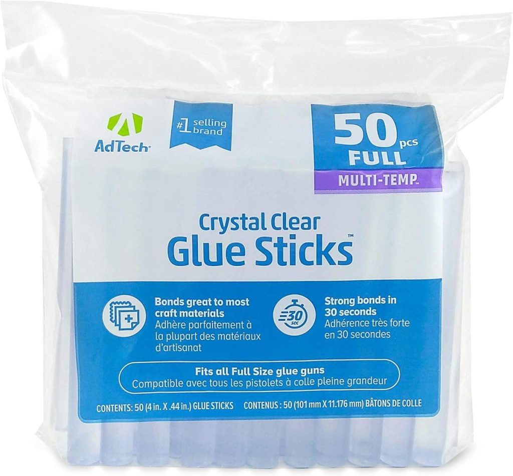 A package of AdTech Crystal Clear Glue Sticks, 50 full-size pieces, labeled multi-temp, perfect for crafts like Glitter Christmas Trees, with product features and dimensions printed on the front.