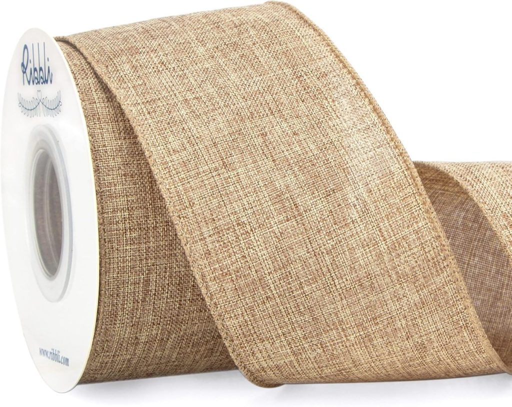 A spool of wide, textured burlap ribbon with a natural brown color, partially unrolled, on a white background.