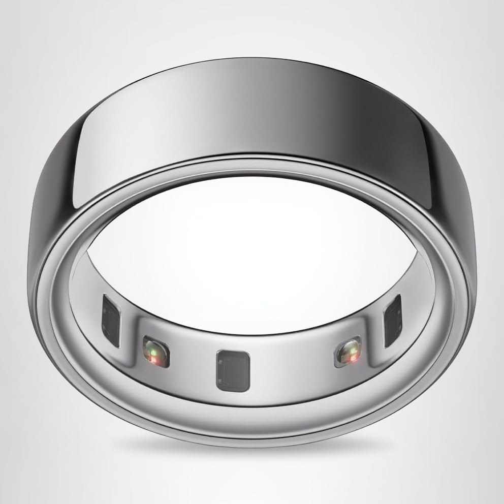 A silver metallic smart ring with embedded sensors visible on the inner side, displayed on a plain light background beside a festive Christmas pillow.