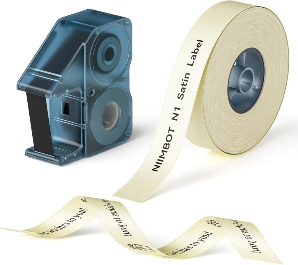 A satin label tape cartridge and a roll of cream-colored label tape, printed with "NIIMBOT N1 Satin Label" in black text.