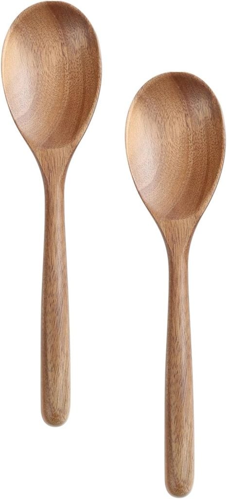 Two wooden spoons with rounded handles and bowls, placed side by side on a white background.