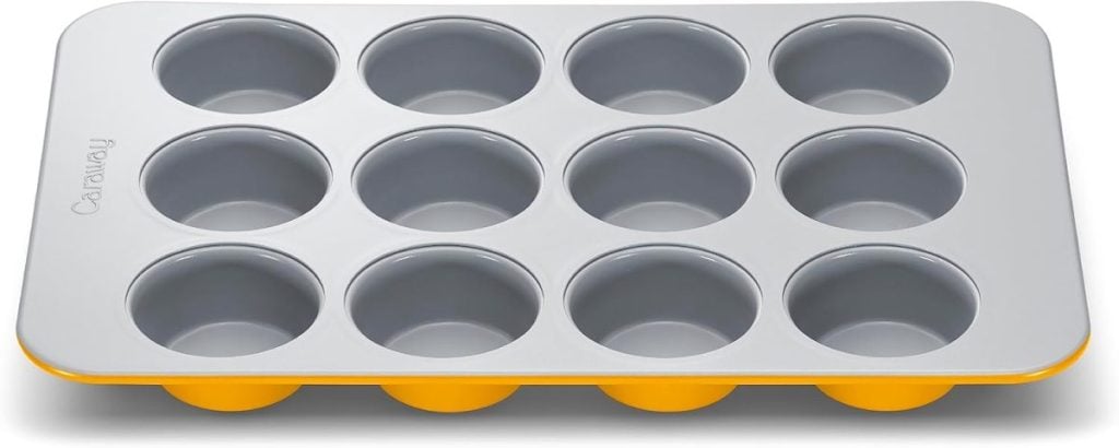 A 12-cup muffin pan with a gray nonstick interior and a yellow base, shown from an overhead angle—perfect for baking treats to feature in blog posts.