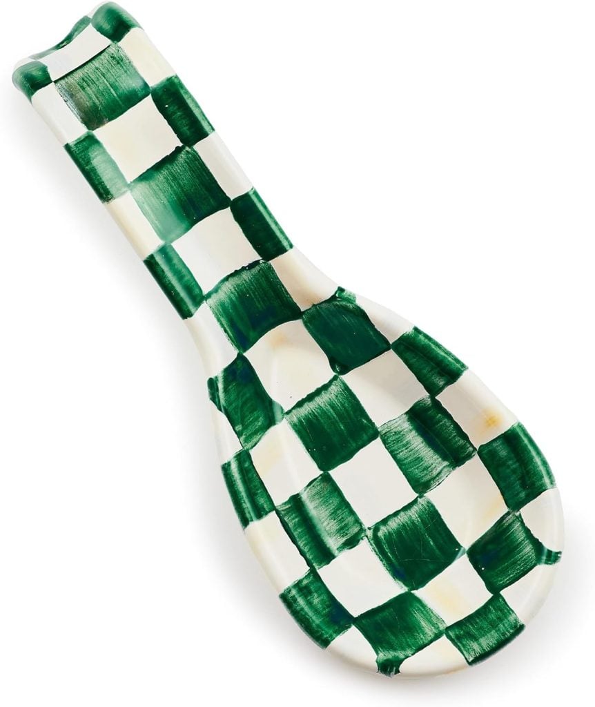 A ceramic spoon rest with a green and white checkered pattern.