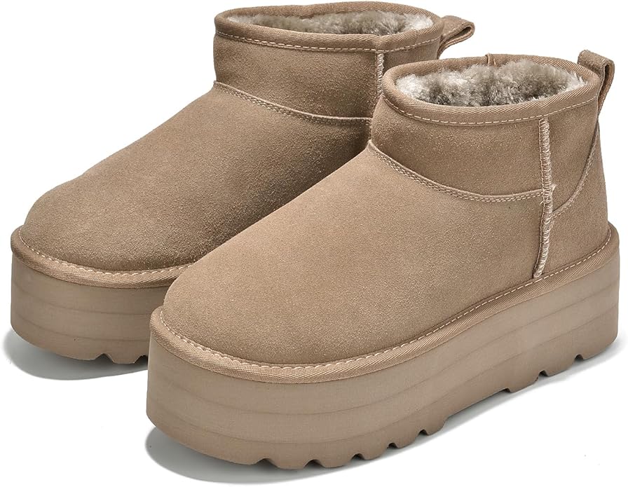 Pair of tan suede platform boots with thick, textured soles and soft, fur-lined interiors displayed on a white background.