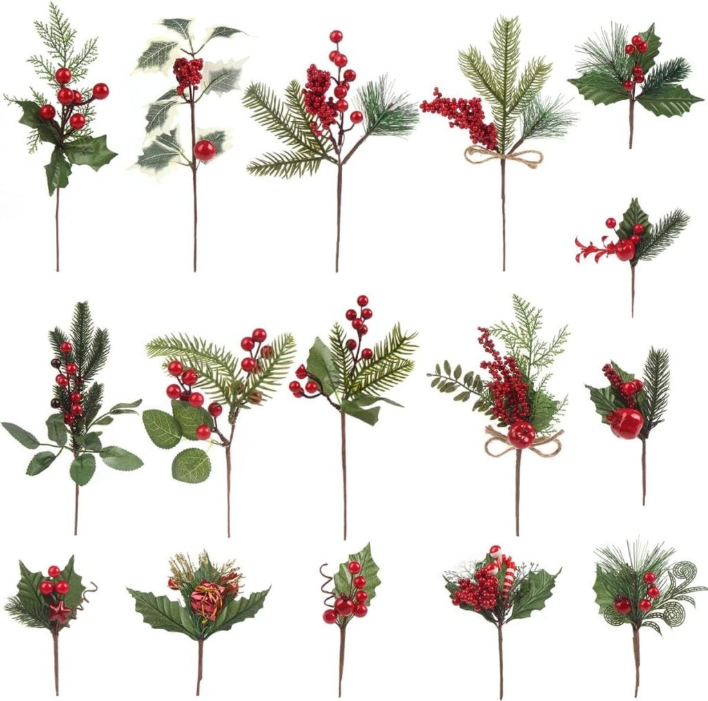 A collection of artificial holiday floral picks featuring red berries, green leaves, pine needles, and holly, arranged in four rows on a white background.