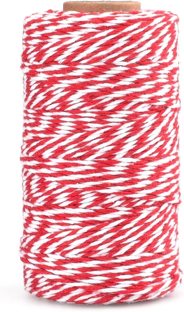 A spool of red and white twisted string or twine, wound tightly around a cylindrical core.