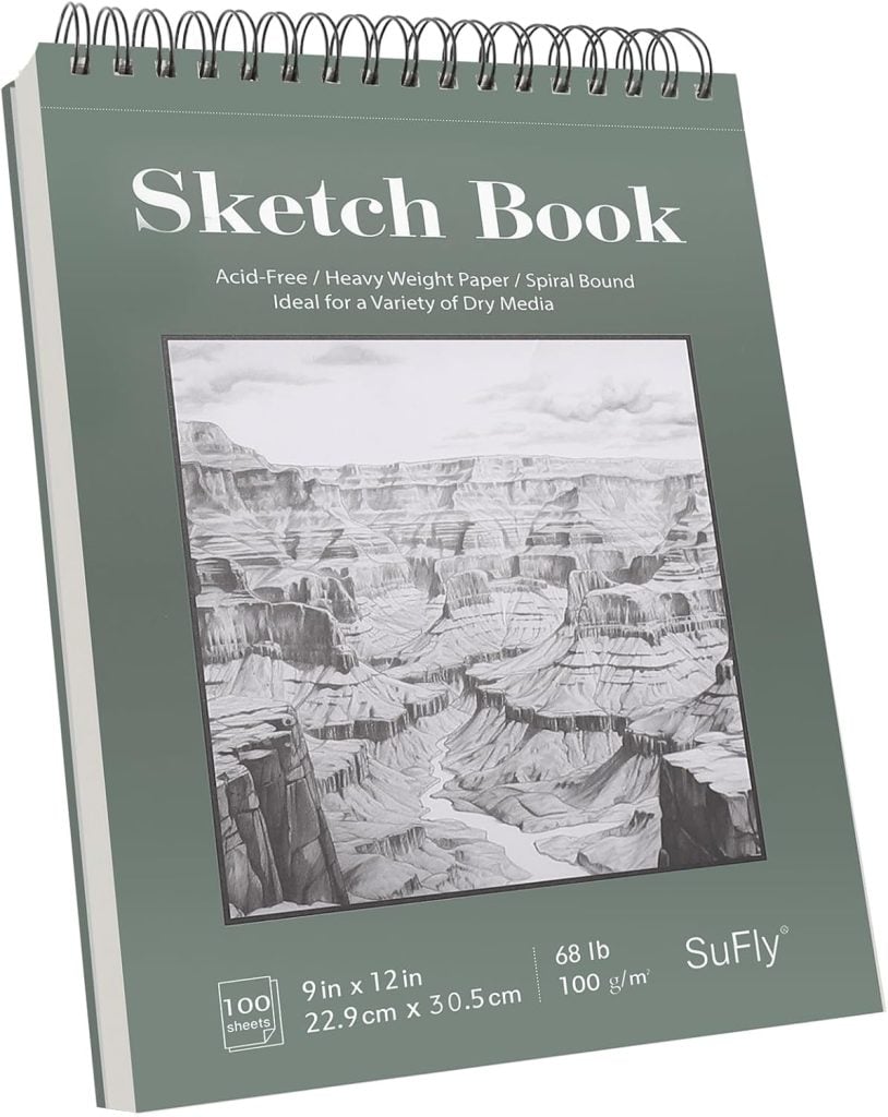A spiral-bound sketch book with a detailed drawing of a canyon on the cover. The book is 9x12 inches, 100 sheets, 68 lb paper, and labeled for dry media.