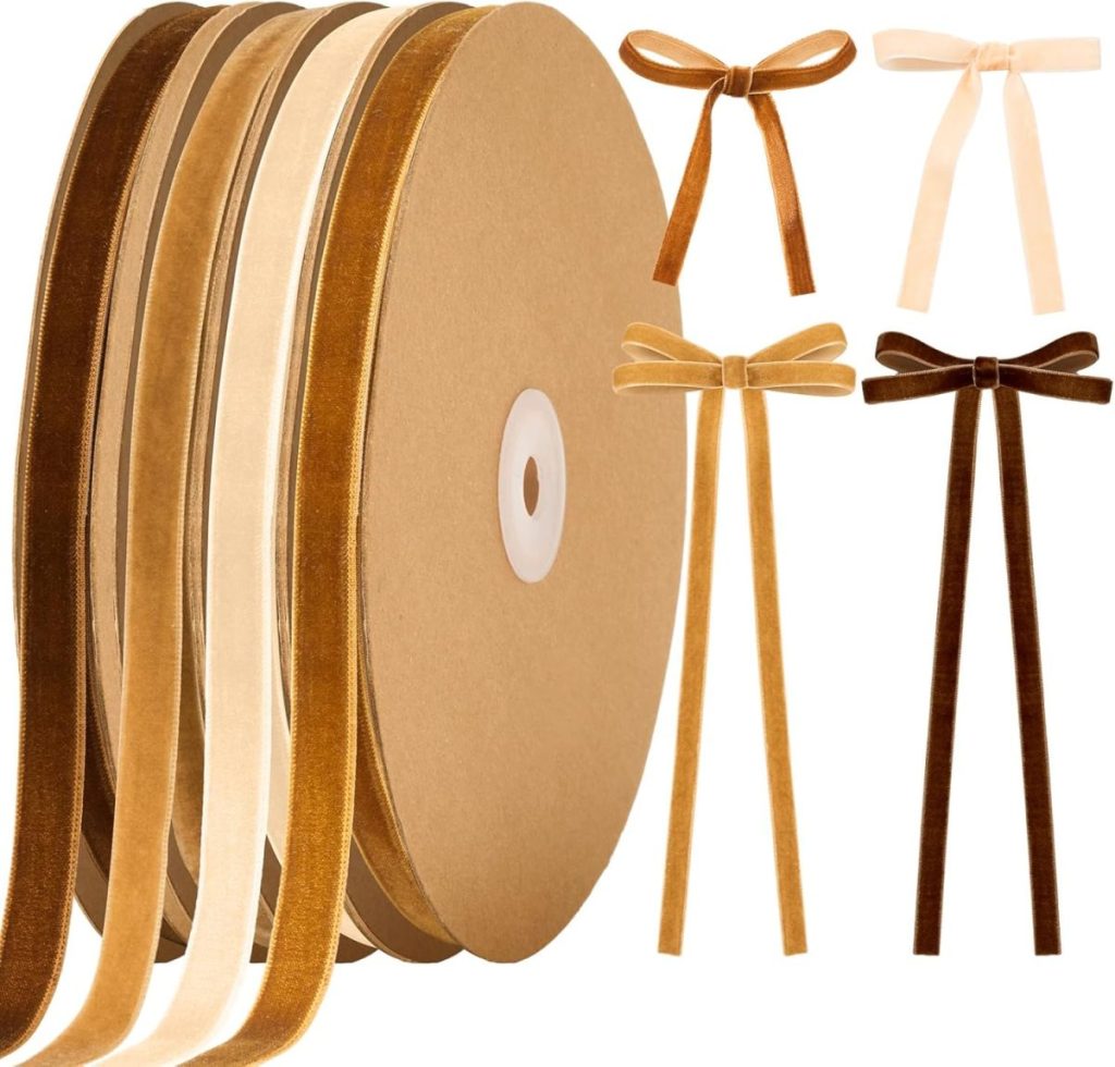 Four spools of velvet ribbon in shades of brown and beige, with matching decorative bows displayed to the right of the spools.