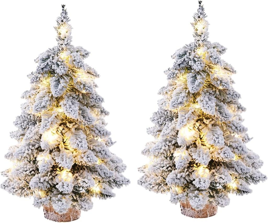 Two artificial snowy Christmas trees with warm white lights stand side by side against a white background, perfect for creating a festive window art display.