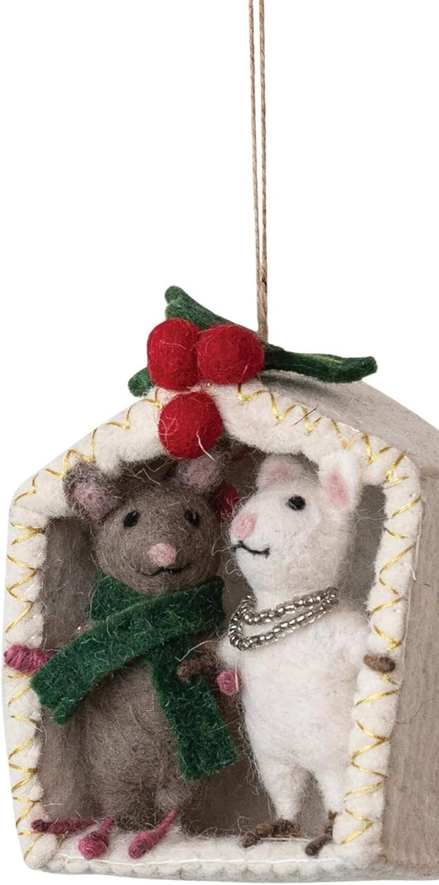 Felt ornament of a gray mouse in a green scarf and a white llama with a necklace inside a small house with holly on top, hanging by a string.