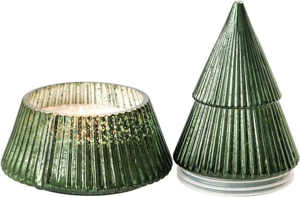 A green, glass candle holder shaped like a Christmas tree is shown. The holder is displayed with one half as a lid and the other half containing a lit candle.