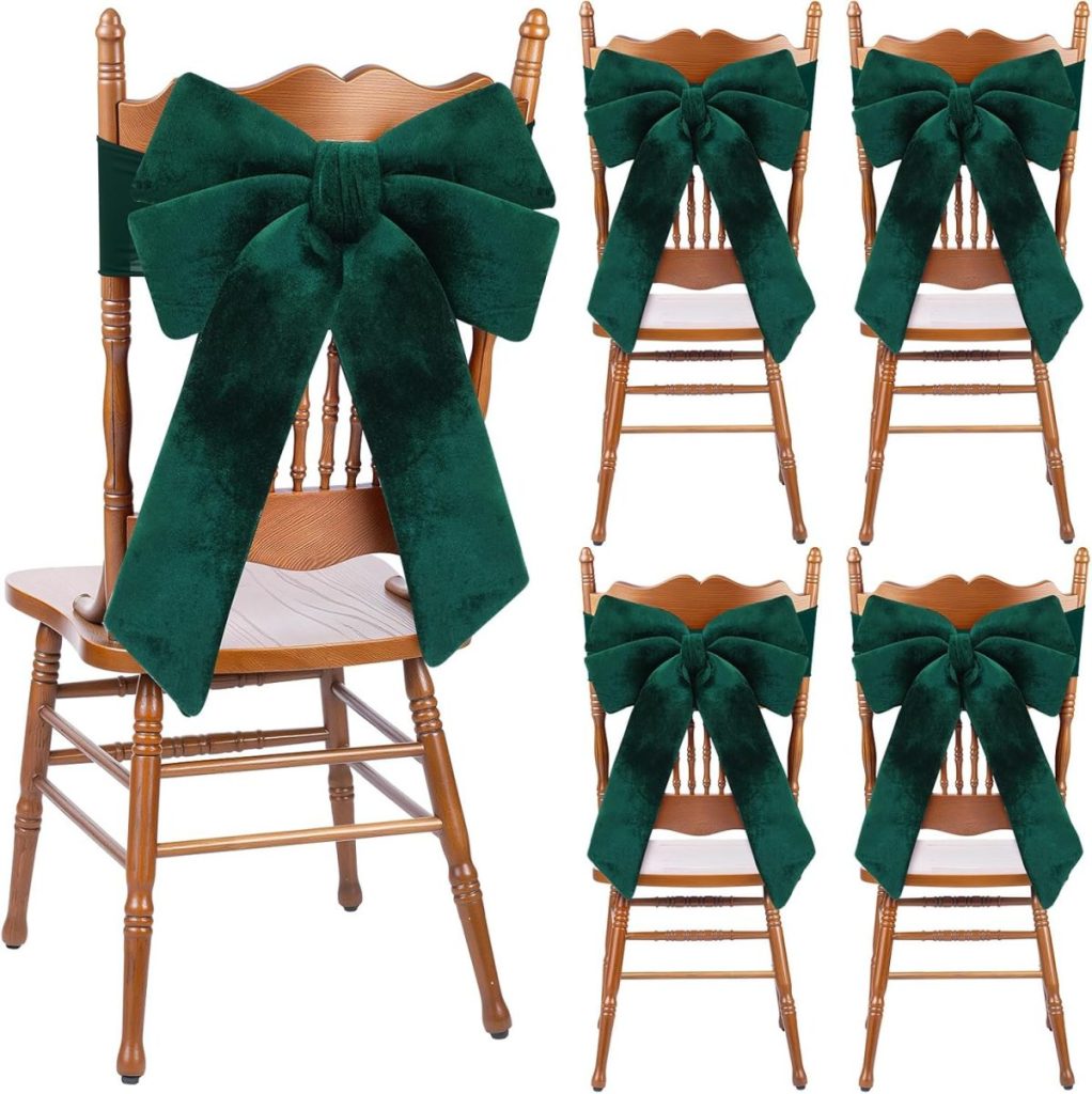 Five wooden chairs with large dark green velvet bows tied around the backs, with one prominently displayed and four arranged in a grid to the side.