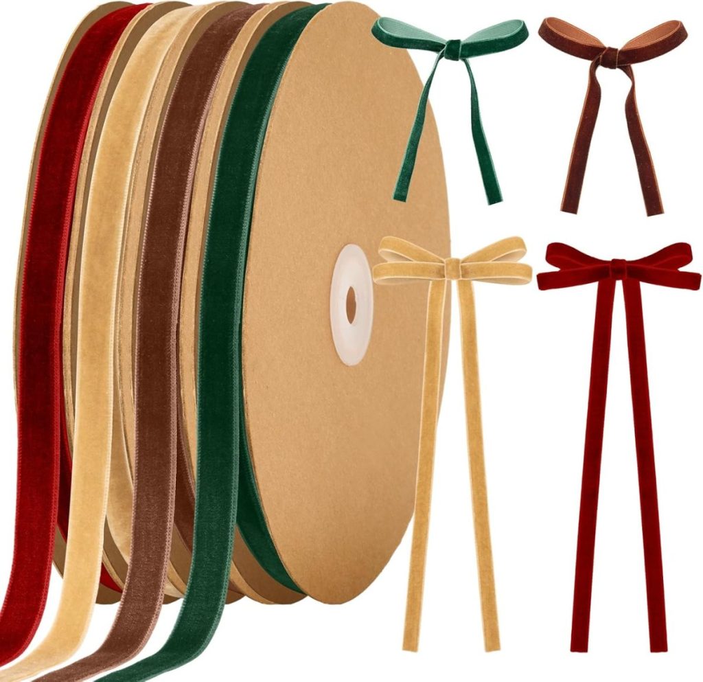 Four rolls of velvet ribbon in red, gold, green, and brown, with matching bows made from each ribbon, displayed on a white background.