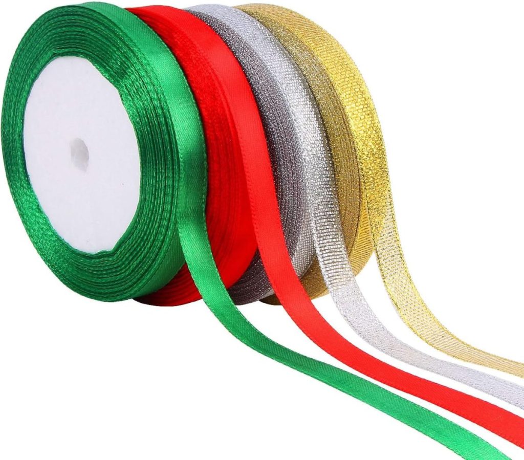 A roll of ribbon displaying five colors—green, red, silver, gold, and white—unspooled on a white background, perfect for adding a festive touch to any hostess gift.