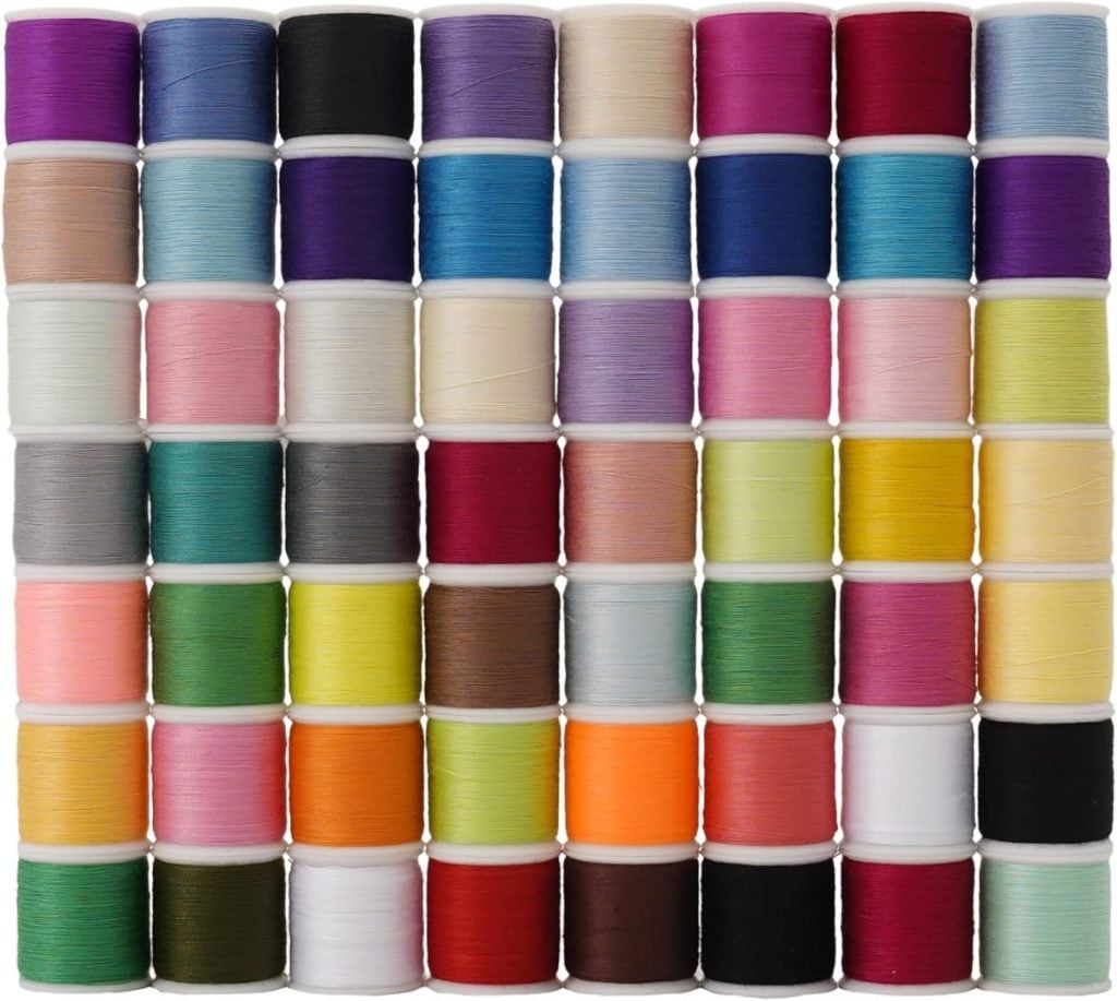 A neatly arranged set of 60 spools of sewing thread in various colors, stacked in rows and columns against a white background.