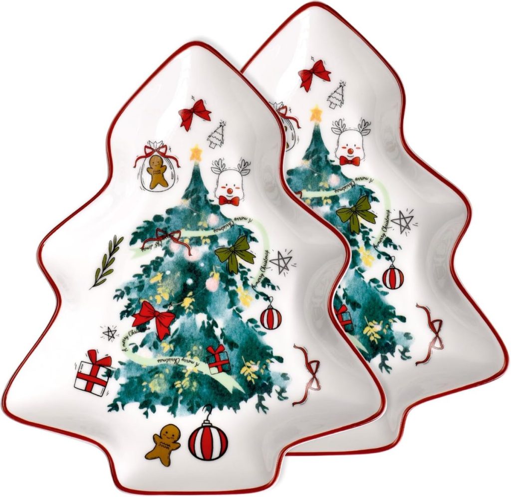 Two ceramic plates shaped like Christmas trees, decorated with holiday-themed illustrations including a tree, gifts, a reindeer, ornaments, and a gingerbread cookie.