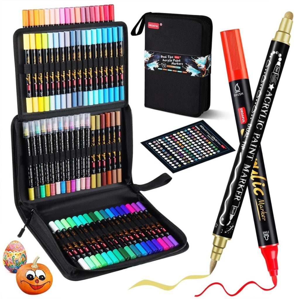 A set of dual-tip acrylic paint markers in various colors, displayed in a black zippered case with color chart—perfect for window art—shown next to two decorated objects and a close-up marker.